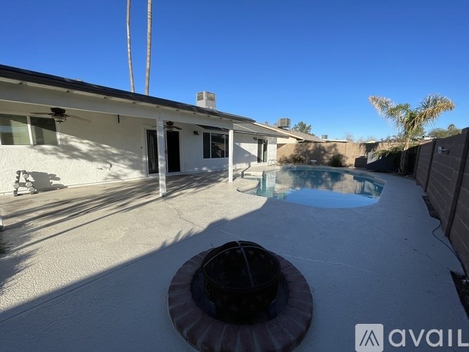 A house with a pool and a hot tub in the backyard.