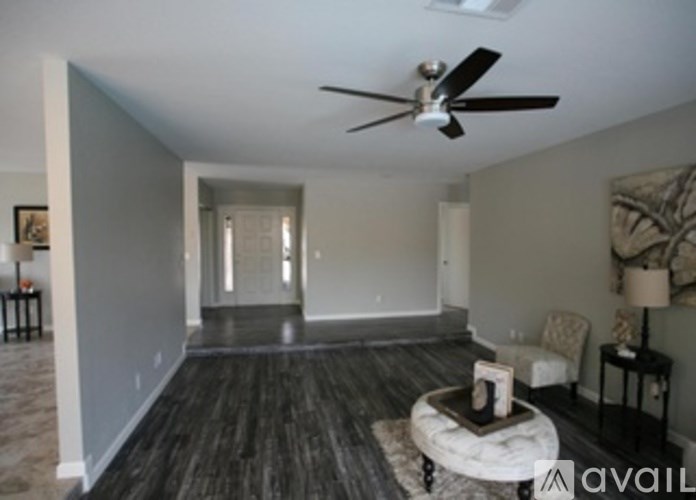 A living room with a ceiling fan and a couch.