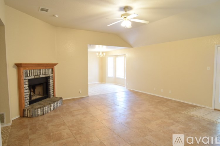 A room with a ceiling fan and a window.
