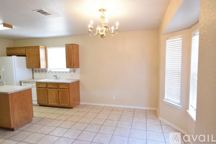 A room with a carpeted floor and a ceiling fan.