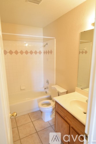 A bathroom with a toilet, sink, and bathtub.