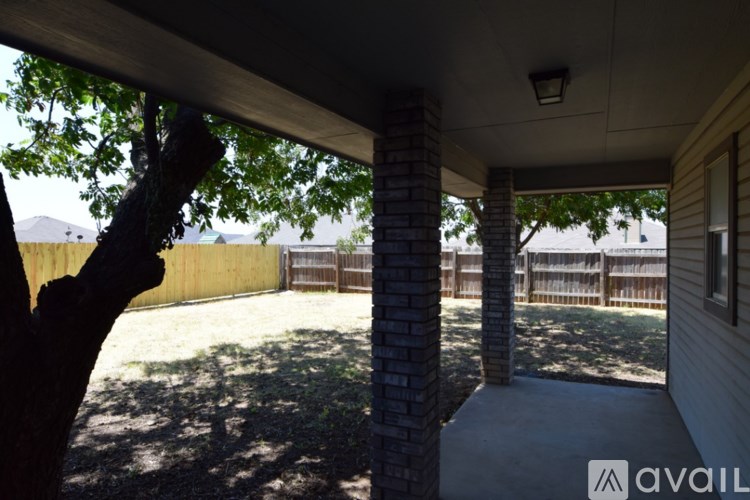 A porch with a tree branch hanging over it.