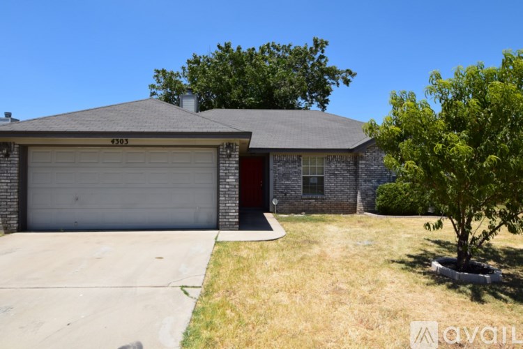A house with a garage and a driveway in front.