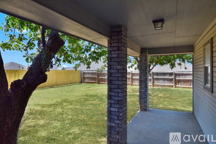 A kitchen with wooden cabinets and a white refrigerator.