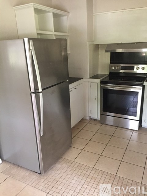 A kitchen with a stainless steel refrigerator and oven.