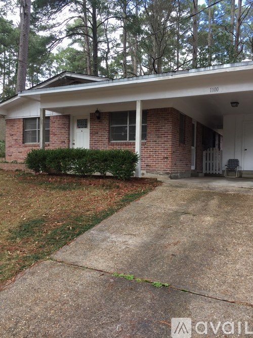 A house with the number 1100 on the front porch.