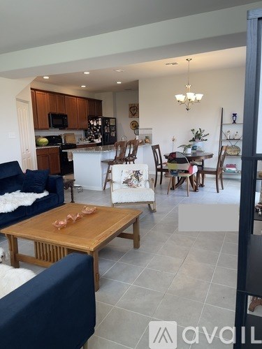 A living room with a blue couch and a wooden coffee table.