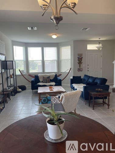 A living room with a brown table and a plant on it.
