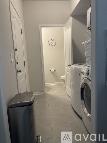 A small laundry room with a washer and dryer.