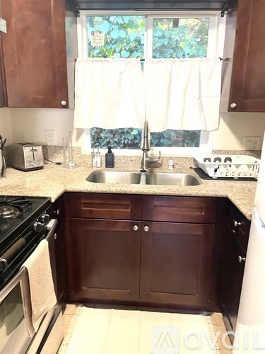 A kitchen with brown cabinets and a white countertop.