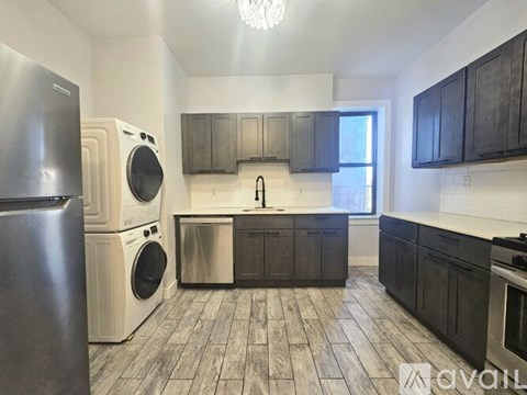 A kitchen with a washer and dryer built in.