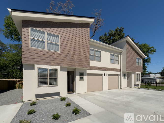 A modern house with a brown and beige exterior is available for purchase.