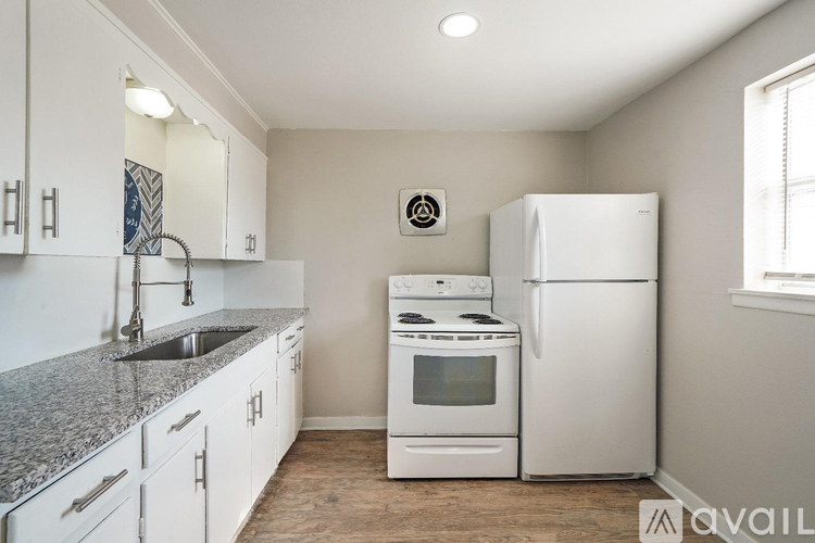 A kitchen with white appliances and cabinets.