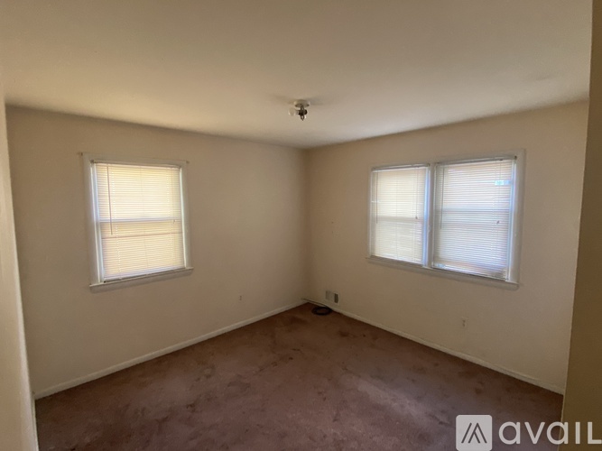 A bedroom with a bed, desk, and chair.