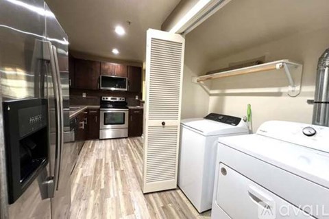 A kitchen with a refrigerator, oven, microwave, and a dishwasher.