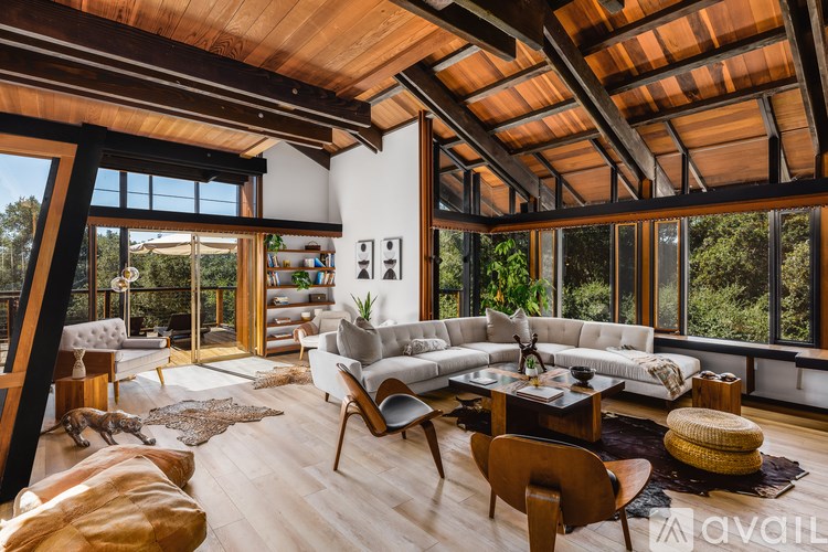 A living room with a white couch and a wooden floor.
