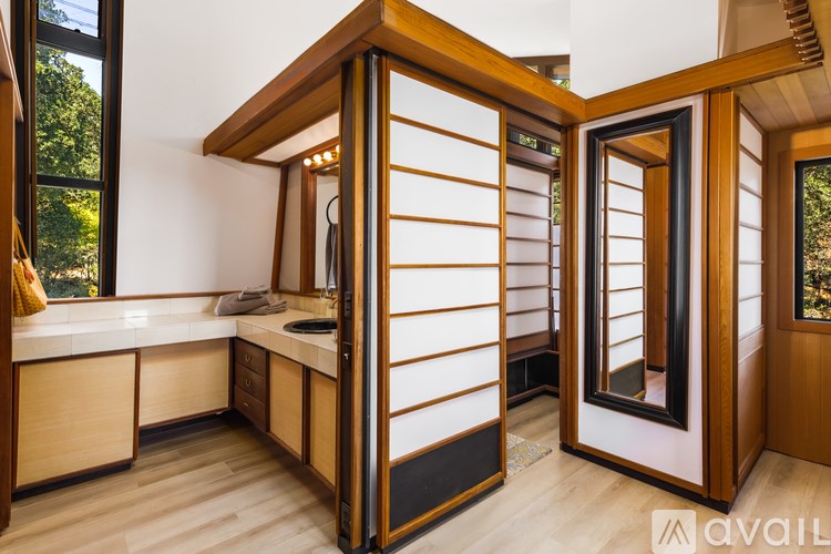 A wooden bathroom with a sink and mirror.