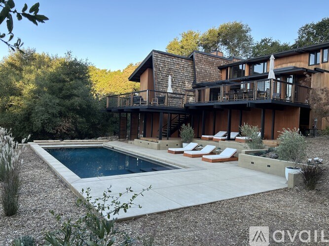 A modern house with a pool in the backyard.