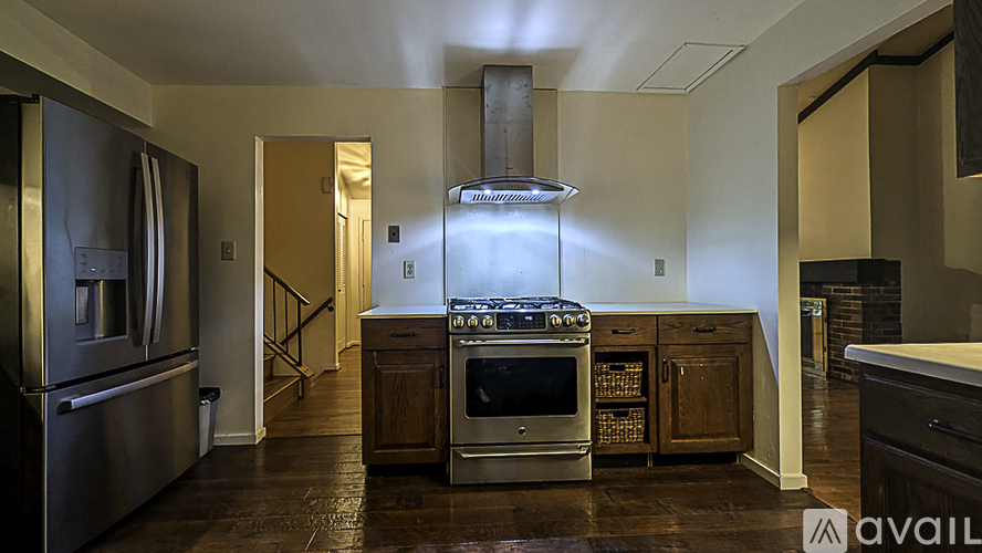 A modern kitchen with a stainless steel refrigerator and a center island with a sink.