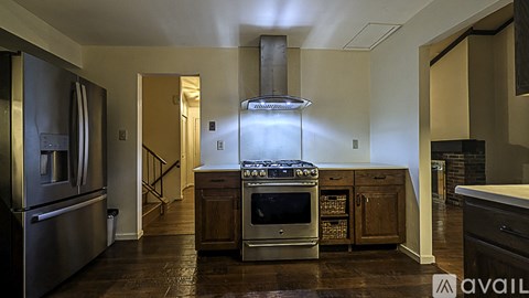 A modern kitchen with a stainless steel refrigerator and a center island with a sink.