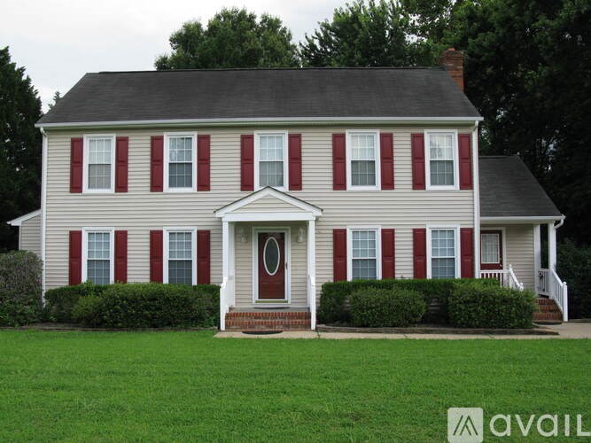 A house with red and white shutters and a red door.