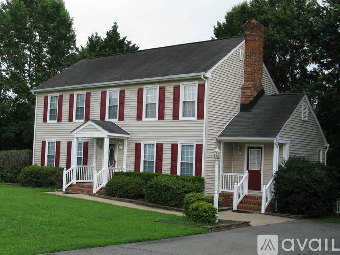 A house with red and white siding and a brick chimney.