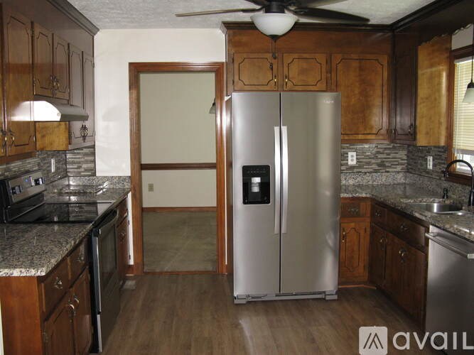 A kitchen with a refrigerator and a stove.