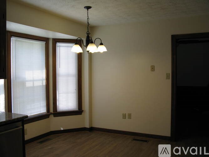A room with a window and a chandelier.