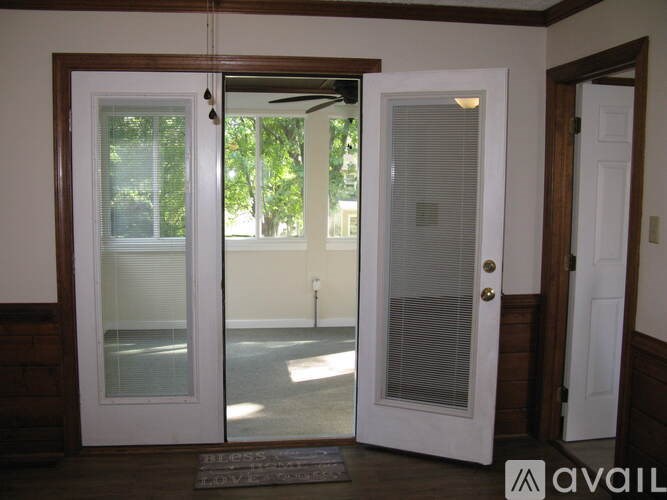 A living room with a fireplace and a ceiling fan.