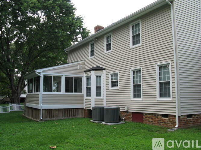 A house with a white fence and a covered porch.