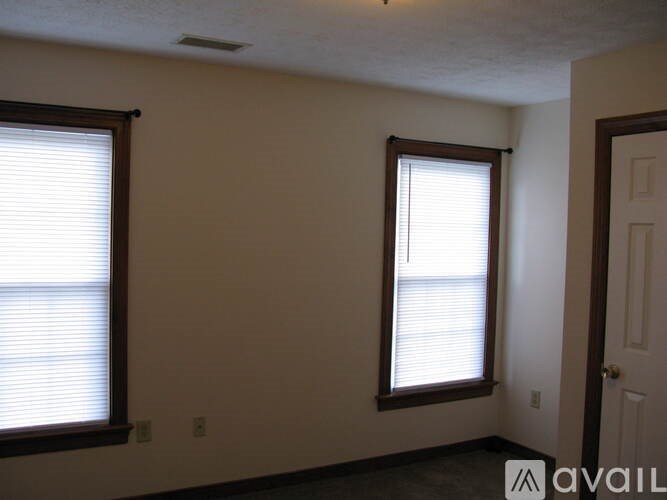 A room with two windows and a door.