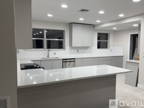 A modern kitchen with a large island in the center.