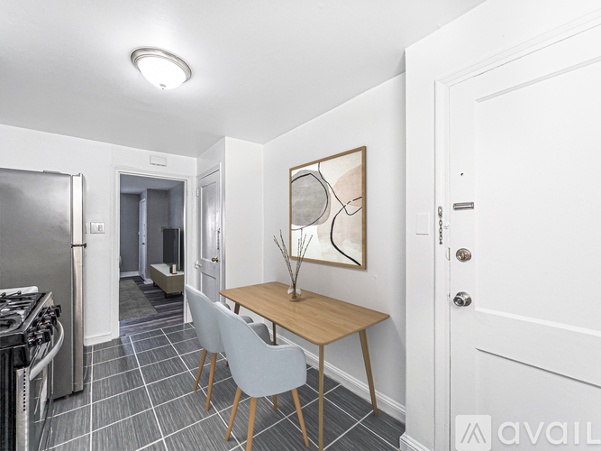 A kitchen with a table and chairs in the middle of the room.