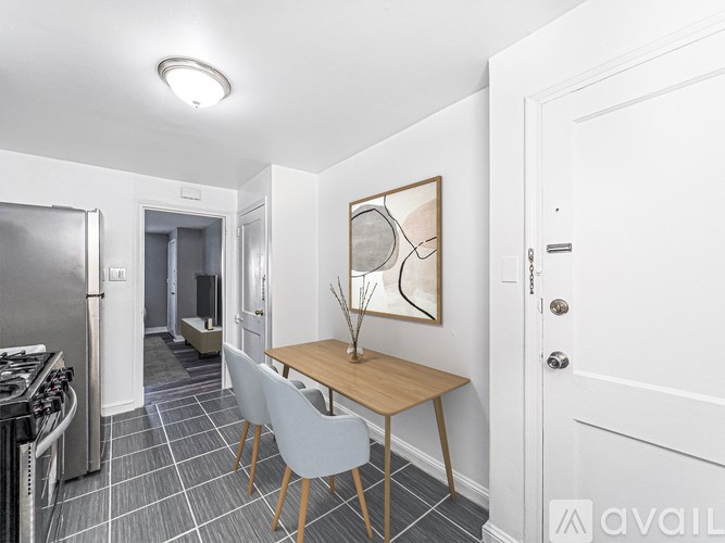 A kitchen with a table and chairs in the middle of the room.