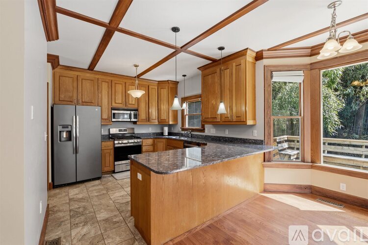 A kitchen with wooden cabinets and a tiled floor.