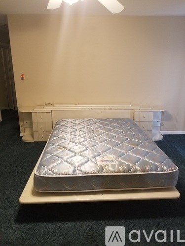 A mattress with a quilted cover is displayed on a platform.