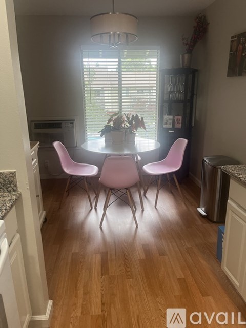 A kitchen with a table and chairs.