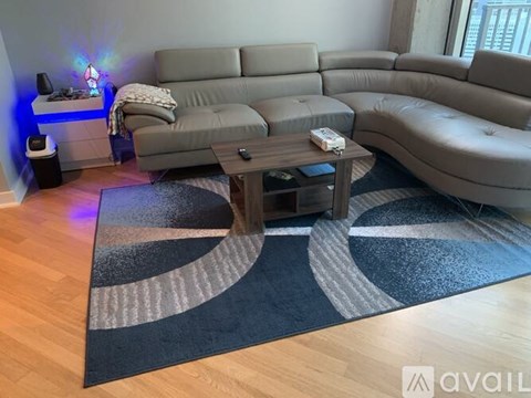 A living room with a grey sofa and a wooden coffee table.