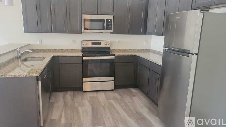 A kitchen with a stove, oven, and refrigerator.