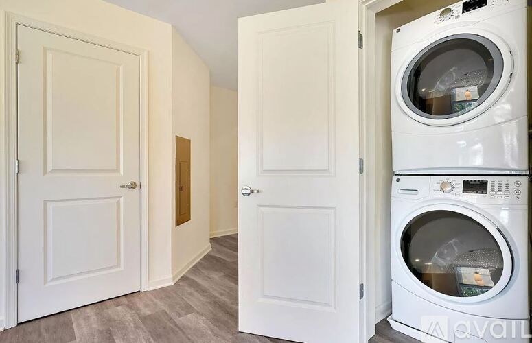 A white door is open to a laundry room.