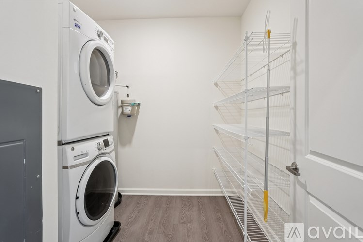 A laundry room with a washer and dryer stacked on top of each other.