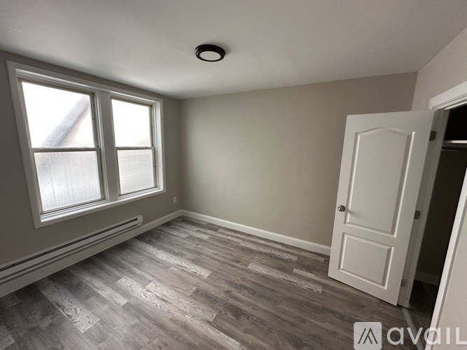 A room with a window and a door.