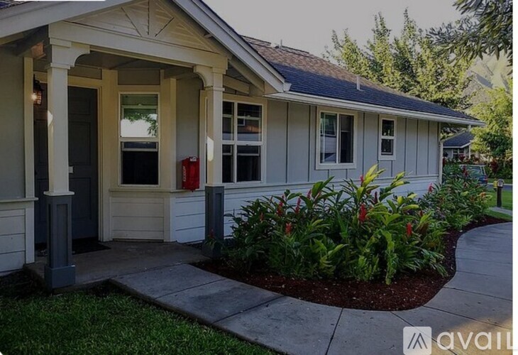 A small house with a porch and a red fire hydrant.