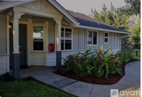 A small house with a porch and a red fire hydrant.