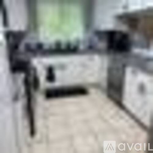 A blurry image of a kitchen with a counter and a sink.
