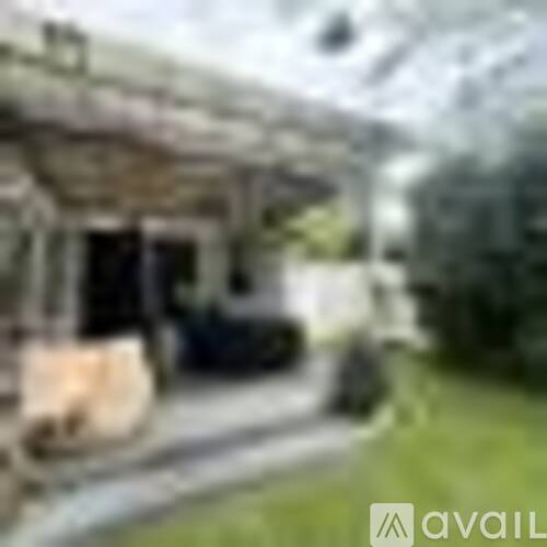 A blurry image of a building with a car parked in front.