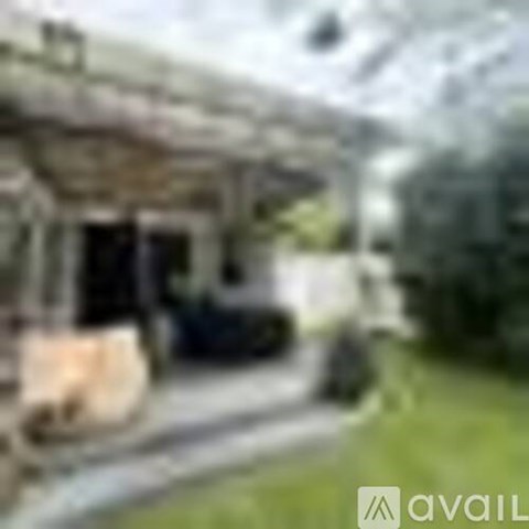 A blurry image of a building with a car parked in front.