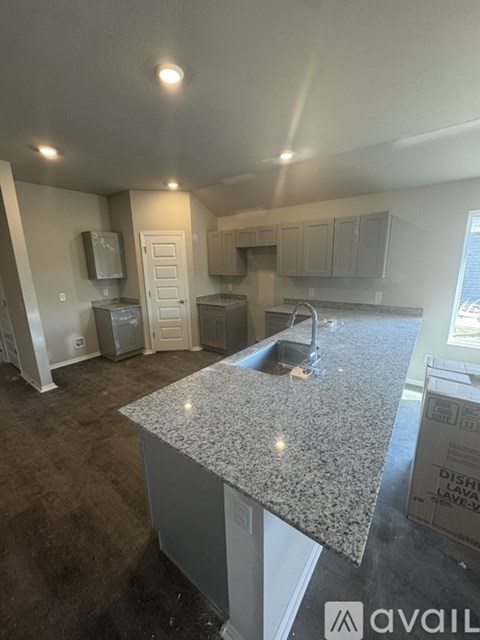A kitchen with granite countertops and a sink.