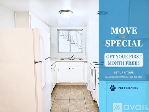 A kitchen with a refrigerator, sink, and cabinets is on display with an advertisement for a free first month of rent.