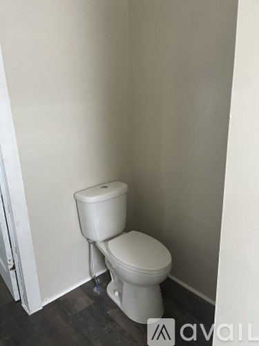A white toilet in a small room.